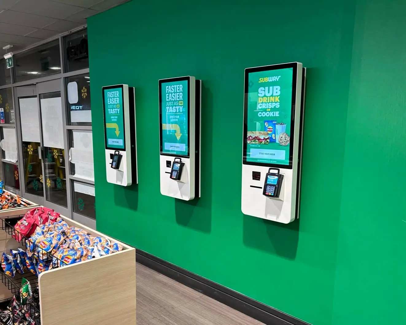 Three self-service ordering kiosks installed in a customer venue