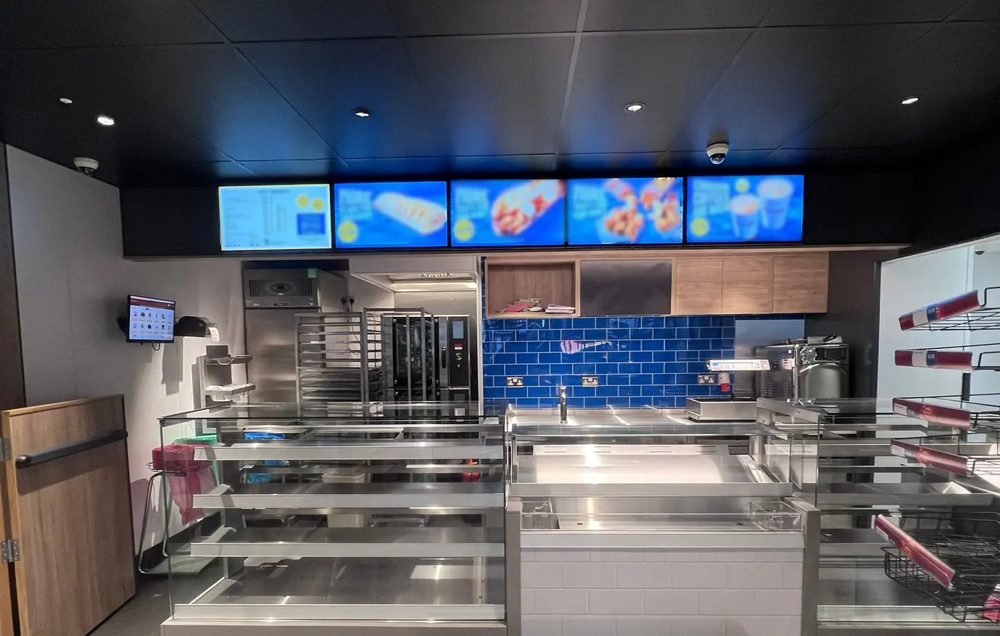 Digital menu boards installed above a customer service counter
